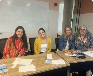 Colleagues writing letters around a table