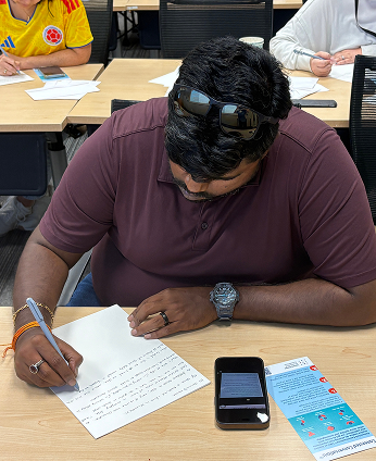 A volunteer writing alone at a table