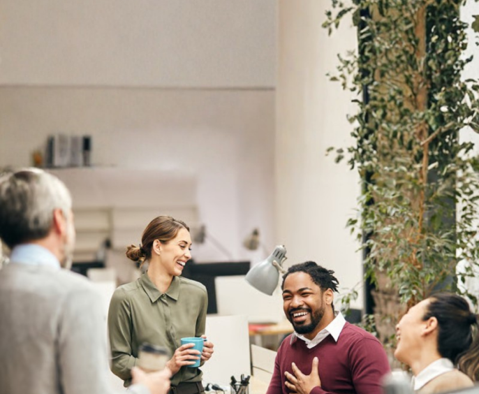 Colleagues in conversation in a bright office