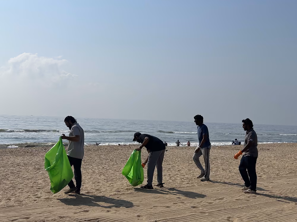 Volunteers clearing trash from a lake shore