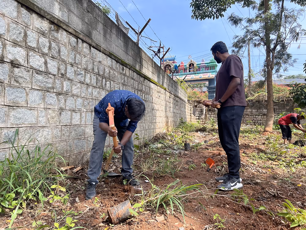 A volunteer clearing litter beside a ball field