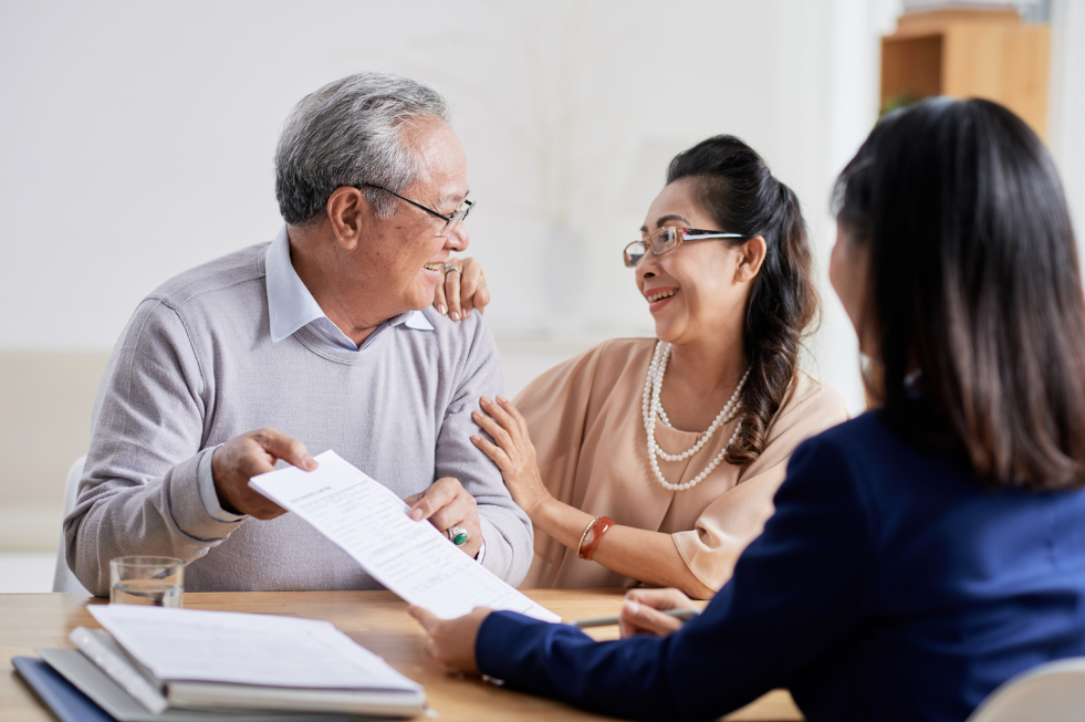 Adults smiling while estate planning for their future.