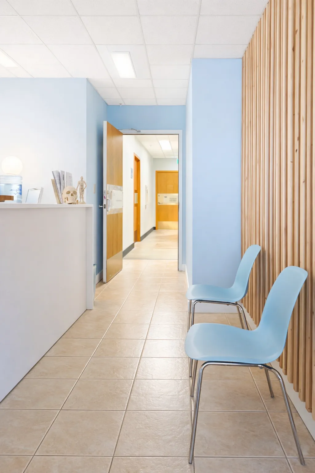 Clinic hallway with reception desk and waiting chairs