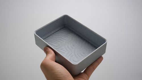 Hand holding 3D printed decorative  modern container