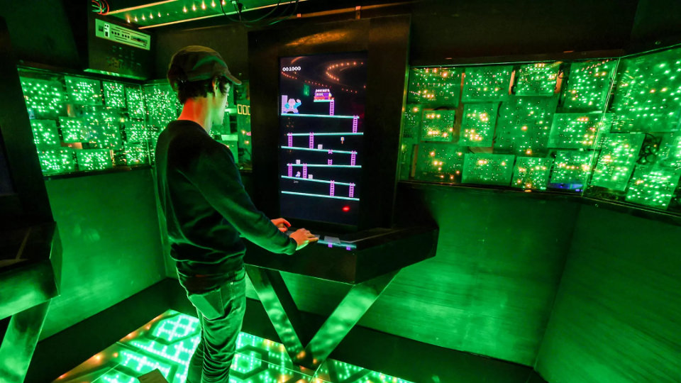 Ladder director Tommy Wallach plays Bossy Kong in the 1980s room.