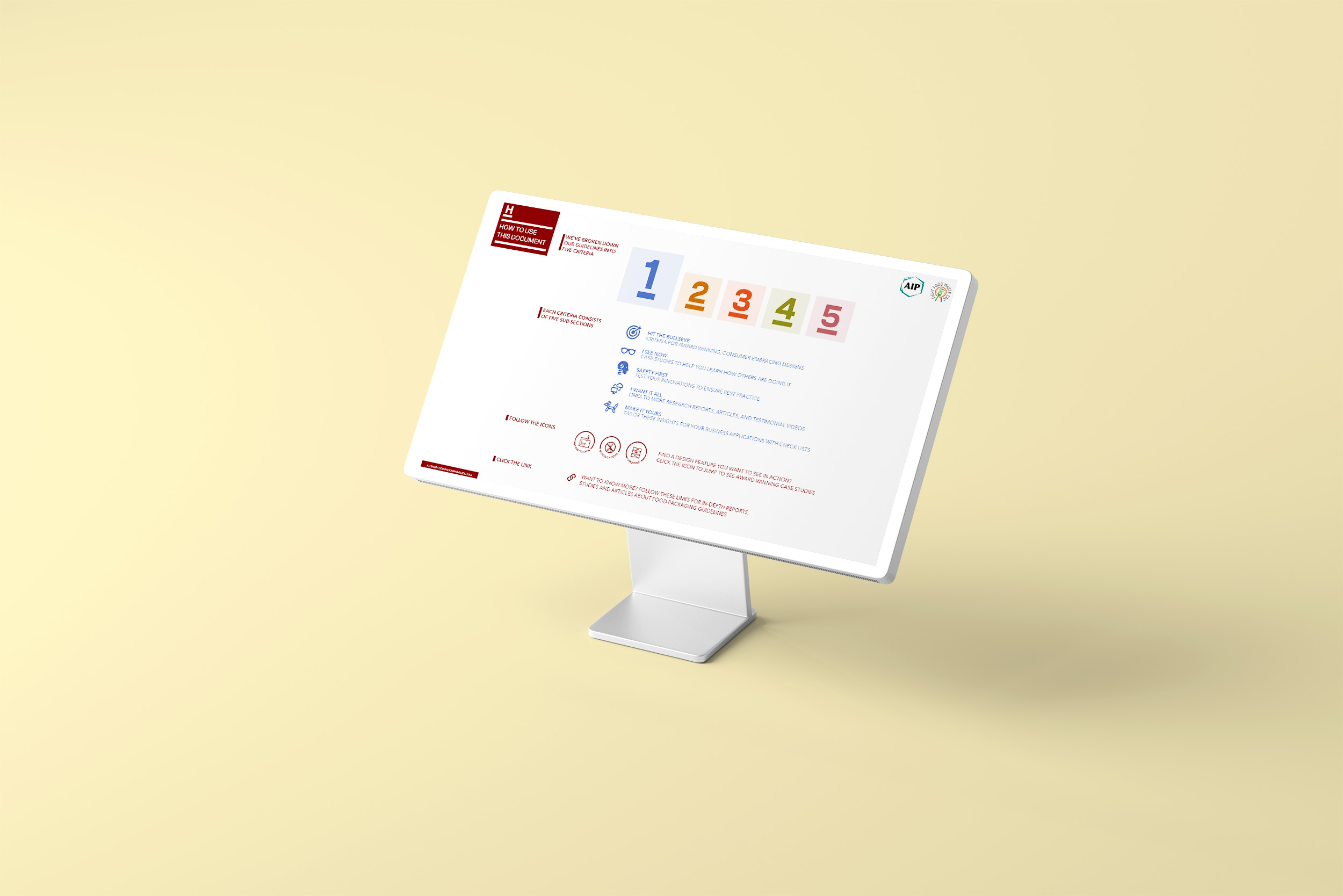 A wide angle looking down at a monitor showing the How-To page from the Save Food Packaging Design Criteria