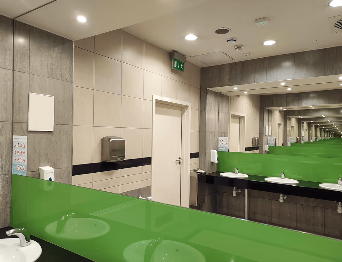 Toilet with green decor and big glass