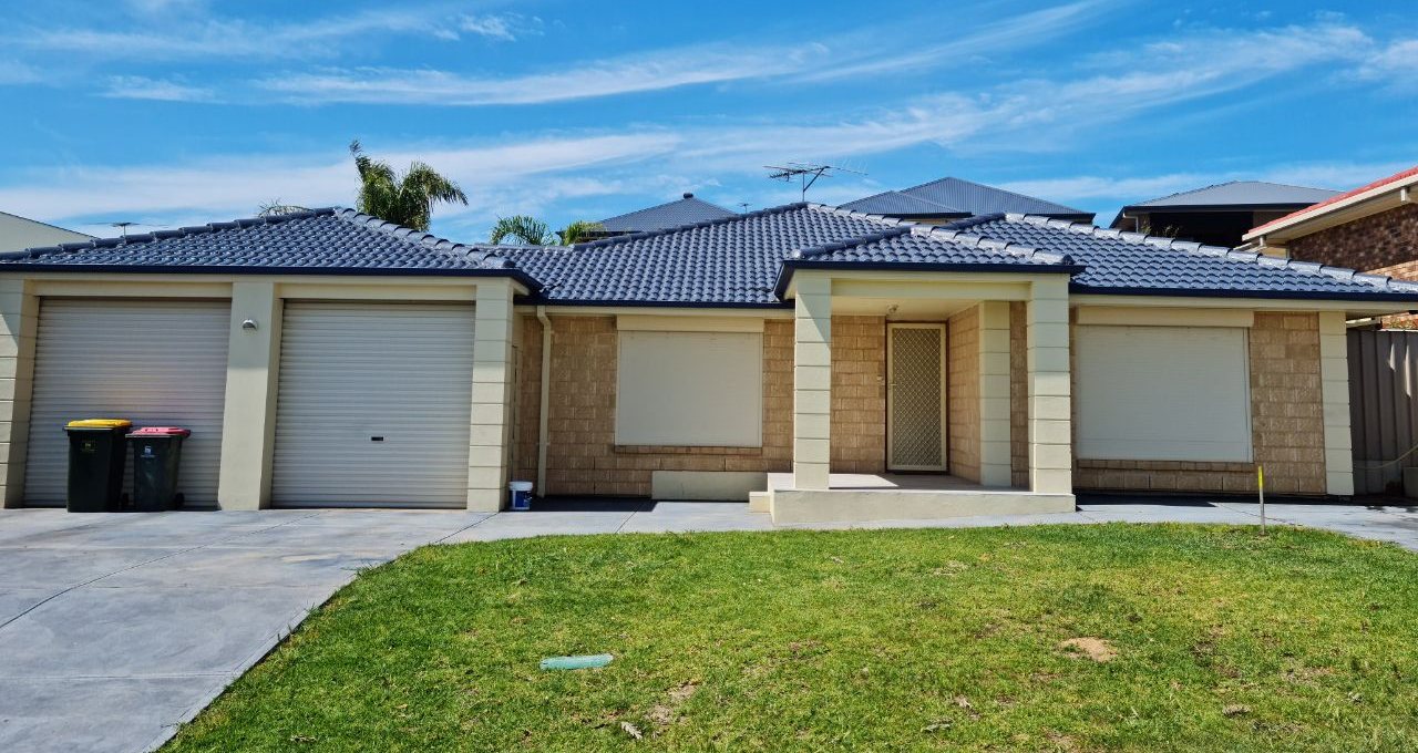 Finished blue-grey tiled roof on a single-storey Adelaide home under a clear summer sky