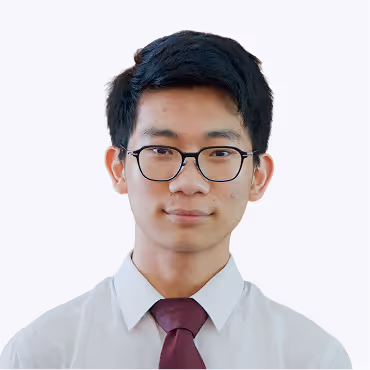 Portrait of a young man with black hair, wearing round glasses, a white shirt, and a maroon tie.