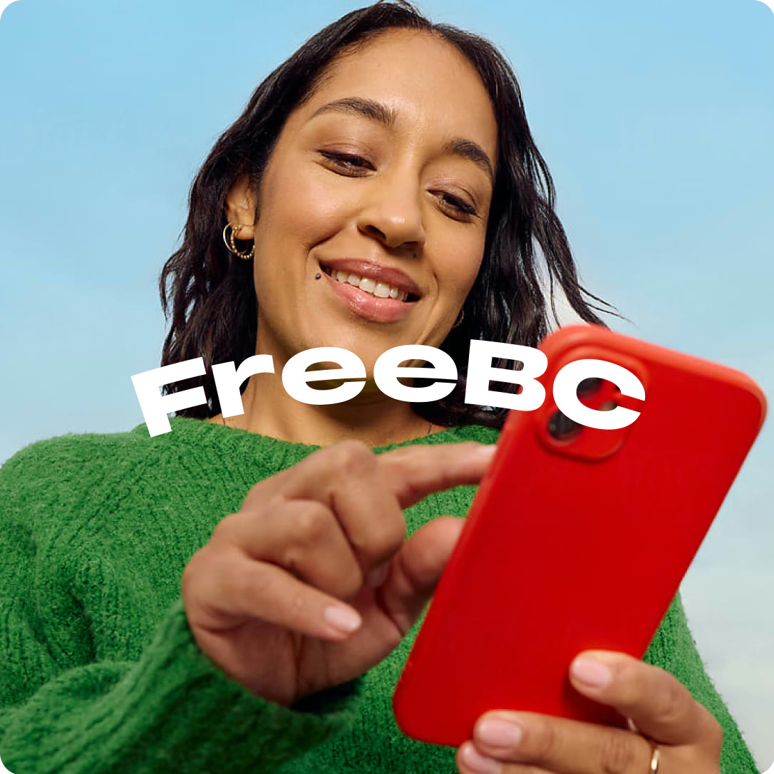 A young woman smiling at her phone with the FreeBC logo