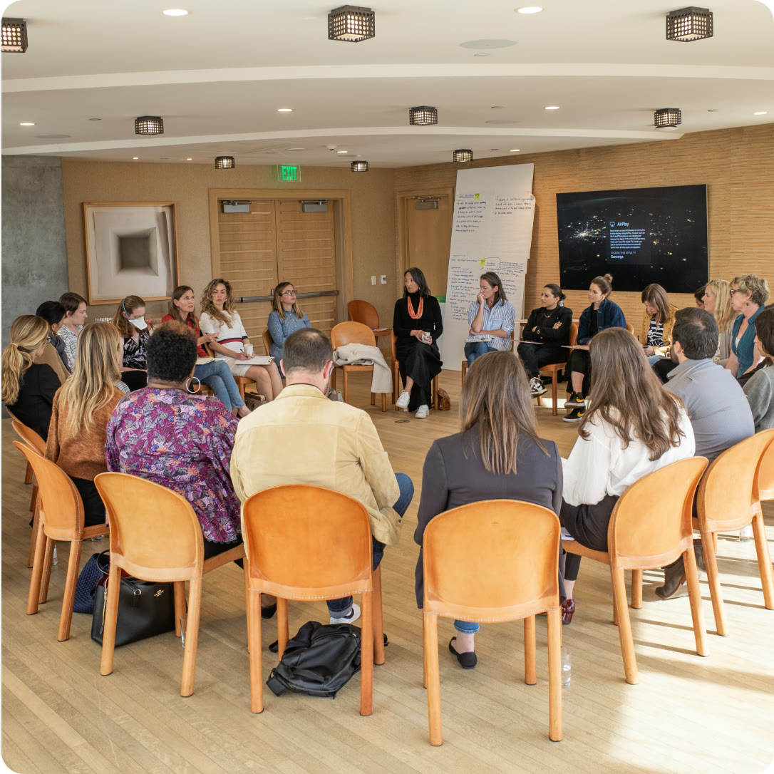A group of caregiving leaders seated in a circle during a workshop