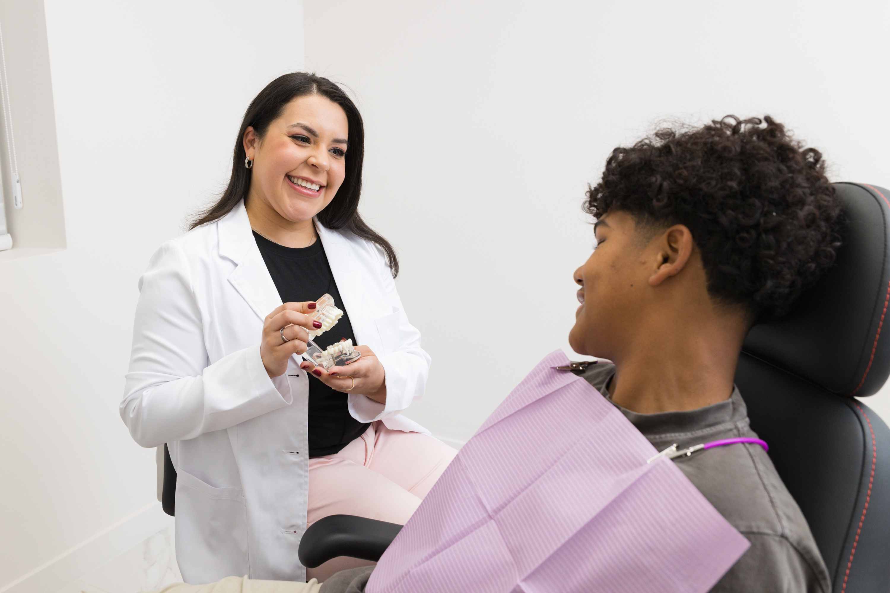 A happy person smiling confidently with a bright, healthy smile, representing the results of a personalized smile makeover through cosmetic dentistry at New Tempo Family Dental.