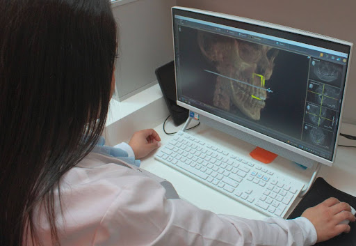 Dentist performing root canal therapy on a patient in a modern dental office