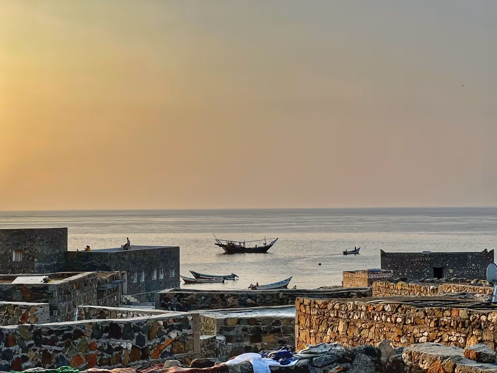 a body of water with boats in it and buildings around it