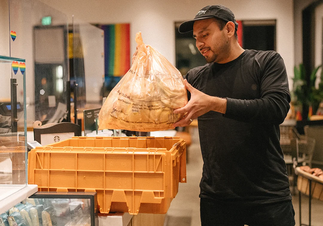 Starbucks employees package surplus food into boxes for distribution to local nonprofits
