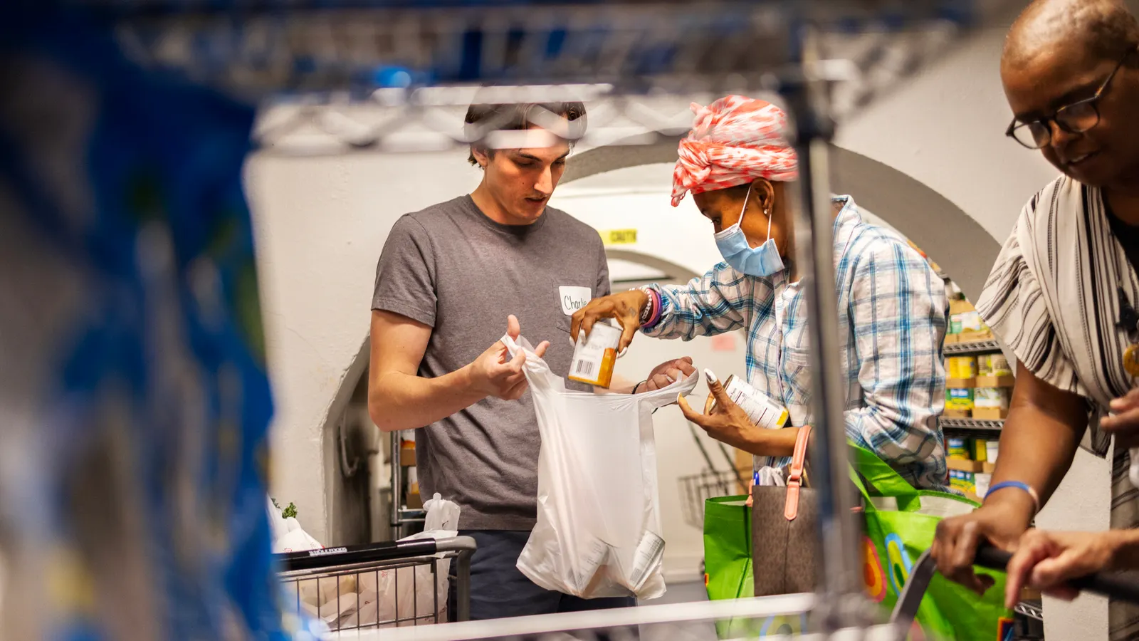 A volunteer packing food supplies into boxes as part of Albertsons and Uber’s food rescue initiative to fight hunger and reduce food waste in U.S. cities.