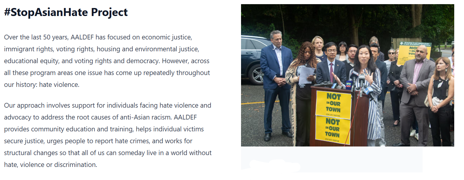 Community leaders and advocates gather at a press conference for AALDEF’s #StopAsianHate Project, standing beside signs reading “Not In Our Town,” to denounce anti-Asian hate and promote unity.