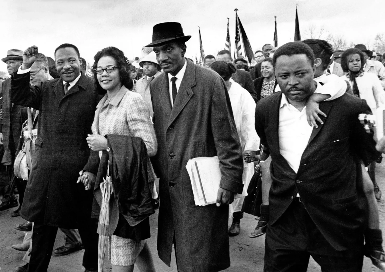Black-and-white photograph of civil rights leaders and supporters walking together during a peaceful march, symbolizing collective action and the fight for racial equality.