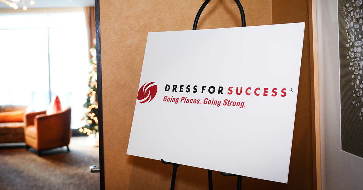 Dress for Success sign displayed indoors, highlighting an organization dedicated to helping women build confidence and succeed in the workplace.