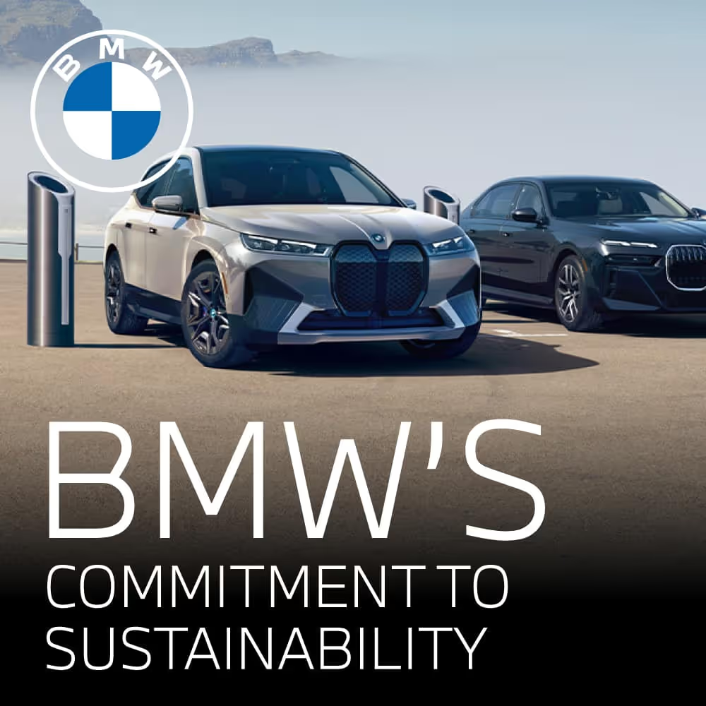 Two BMW electric vehicles parked at charging stations with the BMW logo and the text “BMW’s Commitment to Sustainability,” set against a clean, open landscape.