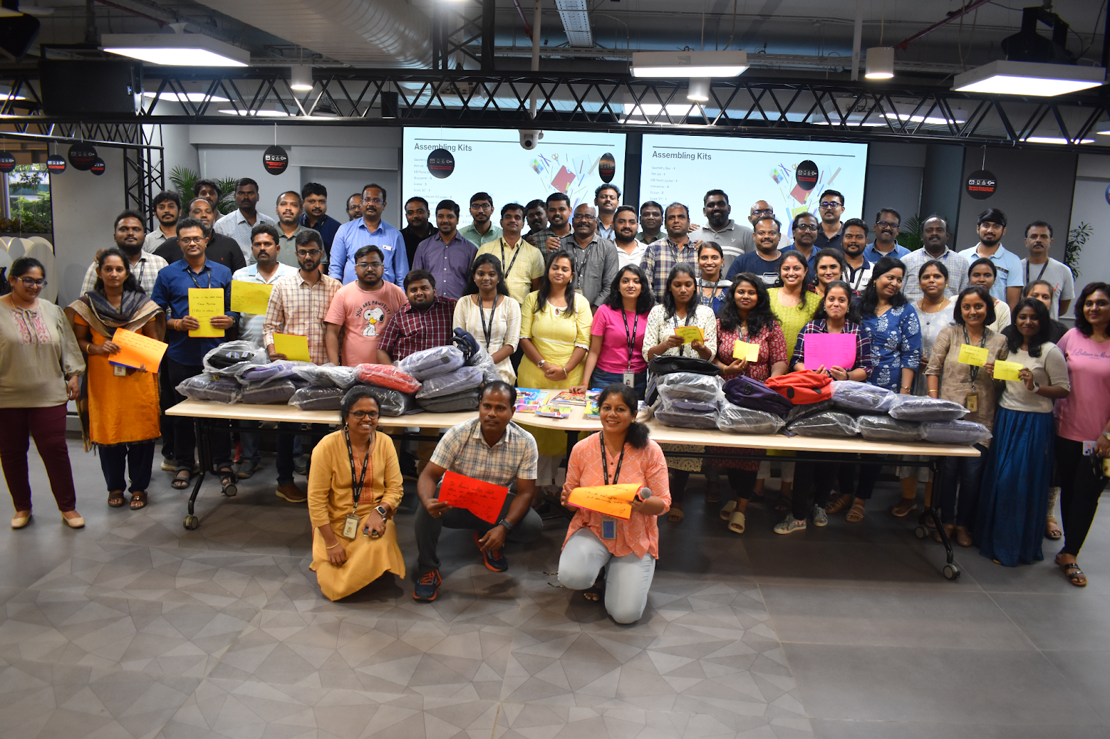Verizon employees assembling kits during a Citizen Verizon Volunteers corporate volunteering event