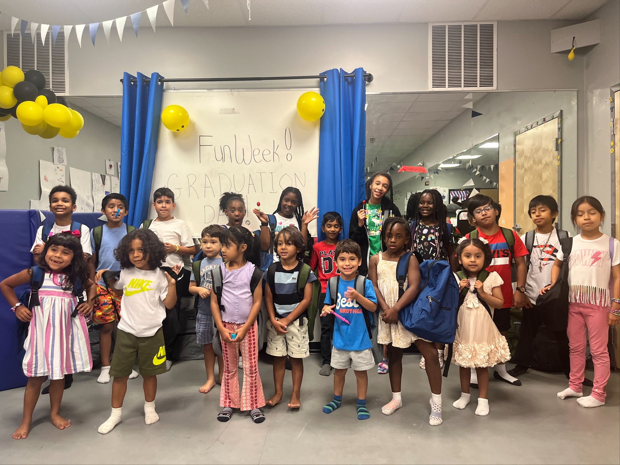 Children supported by the Children Across America pose with their new school supplies donated by employee volunteers working at Mimecast.
