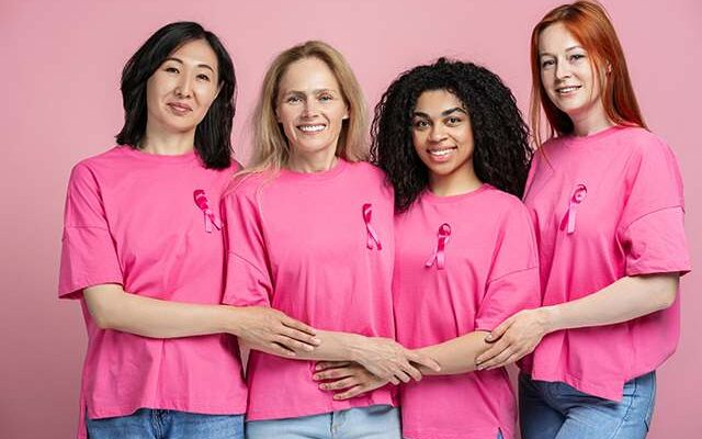 4 employees wearing pink to spread awareness for Breast Cancer