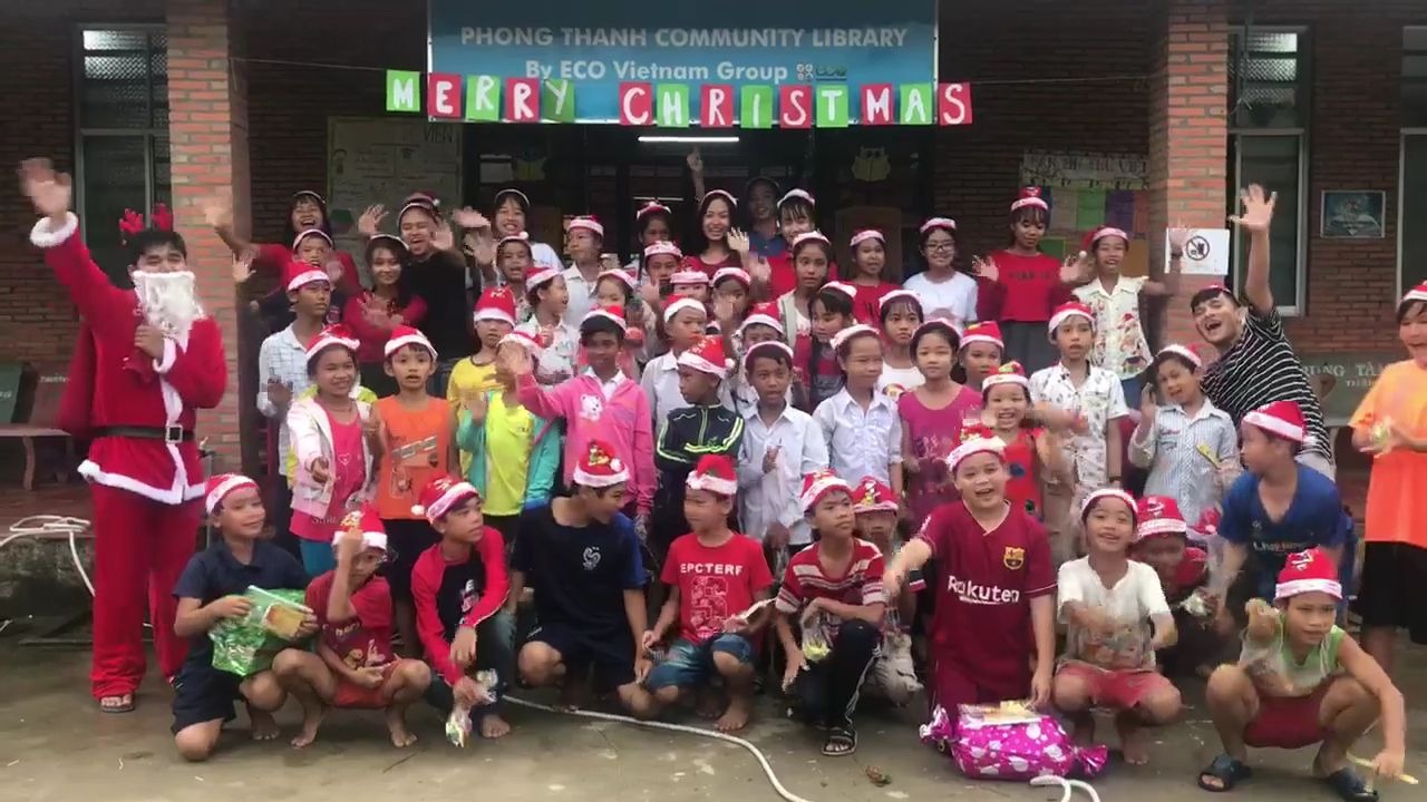 Children and volunteers celebrating a community event organized by ECO Vietnam Group in Vietnam