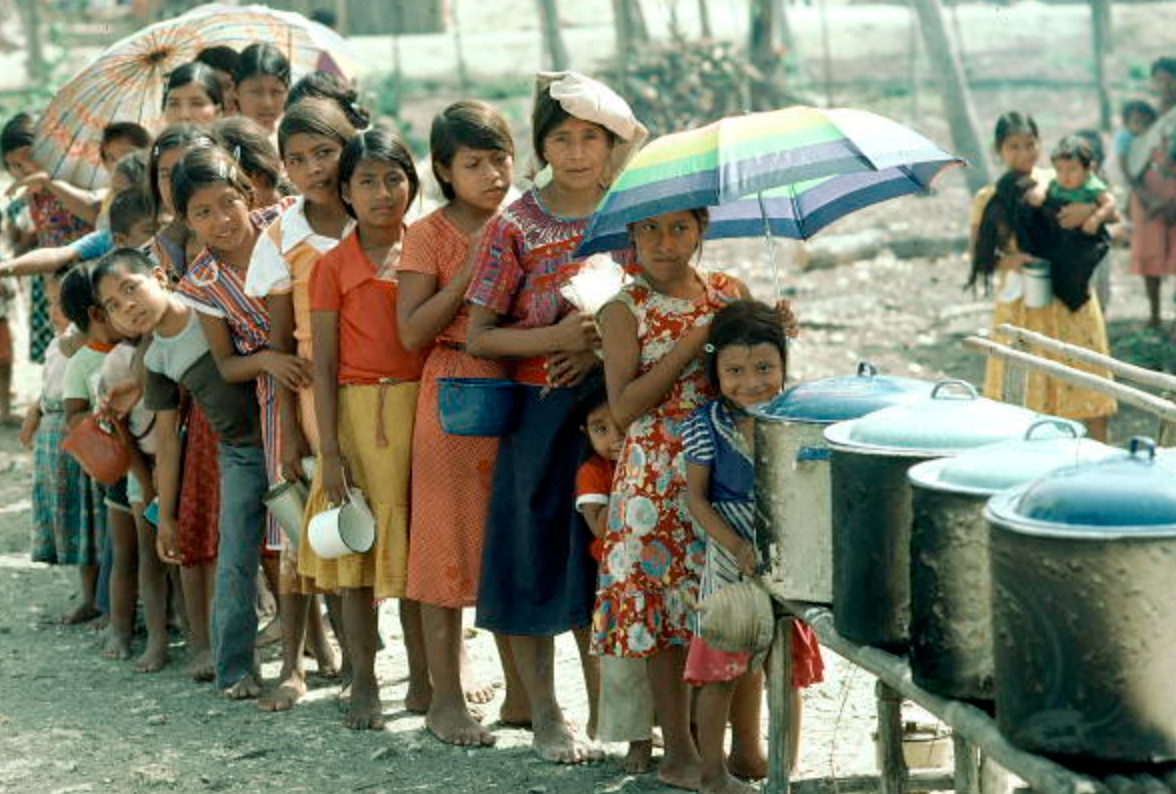 refugee children standing in a line to procure some food