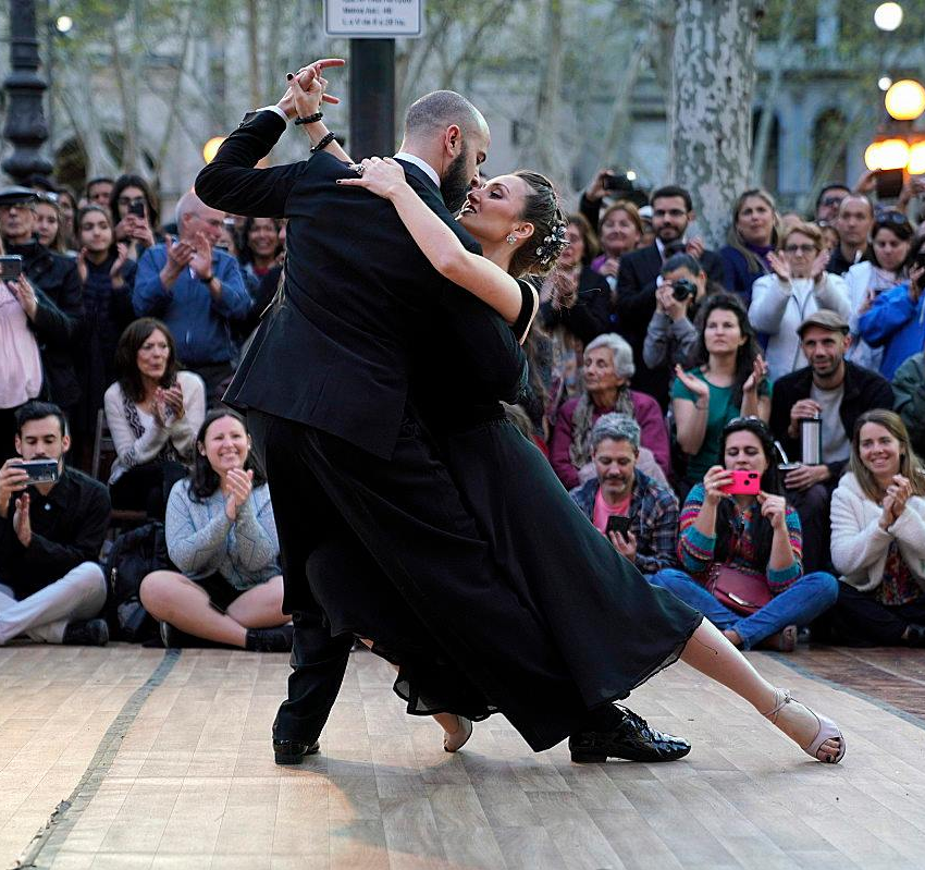 a man and a woman performing the Tango dance