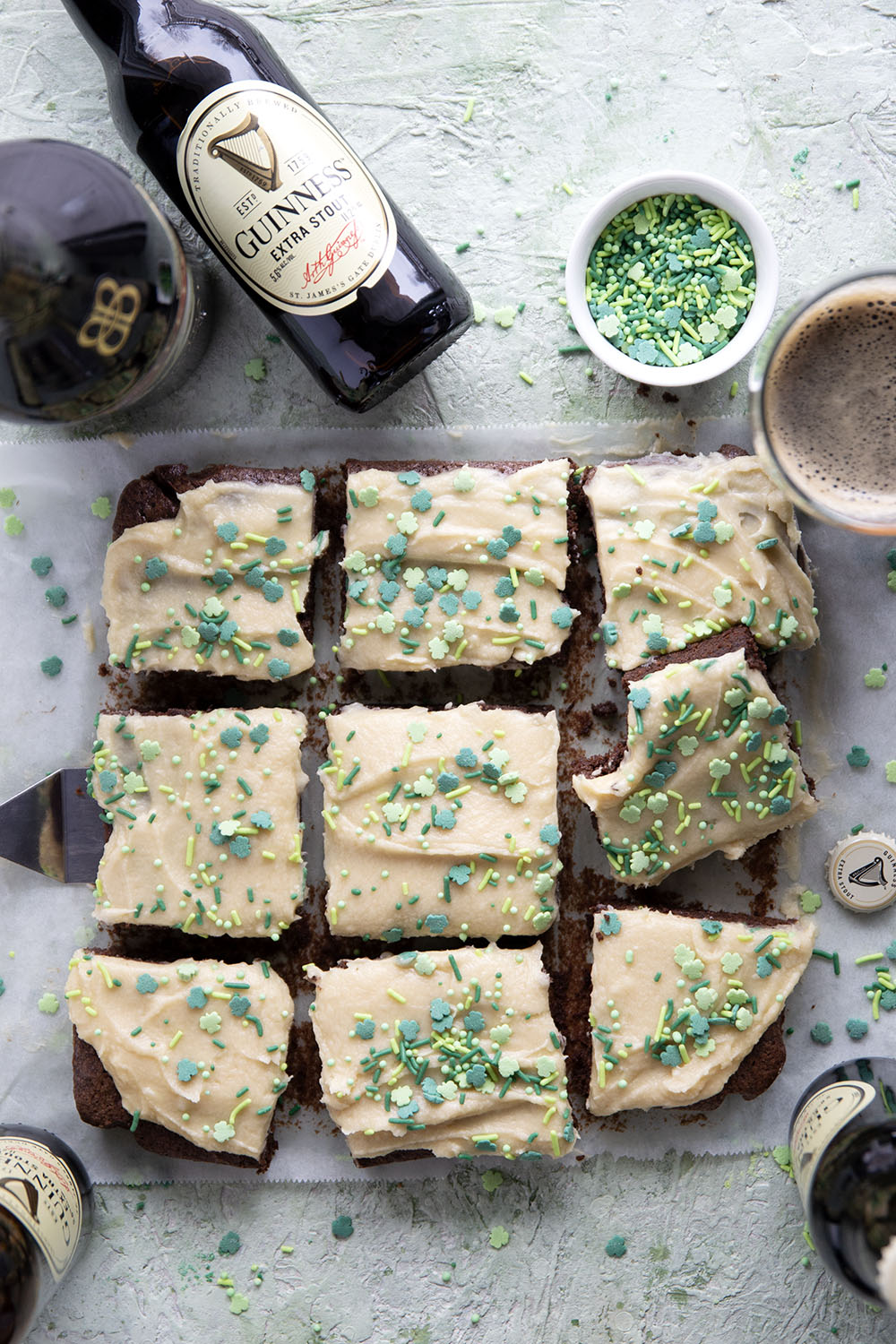 Guinness Brownies with a bowl of green sprinkles and a bottle