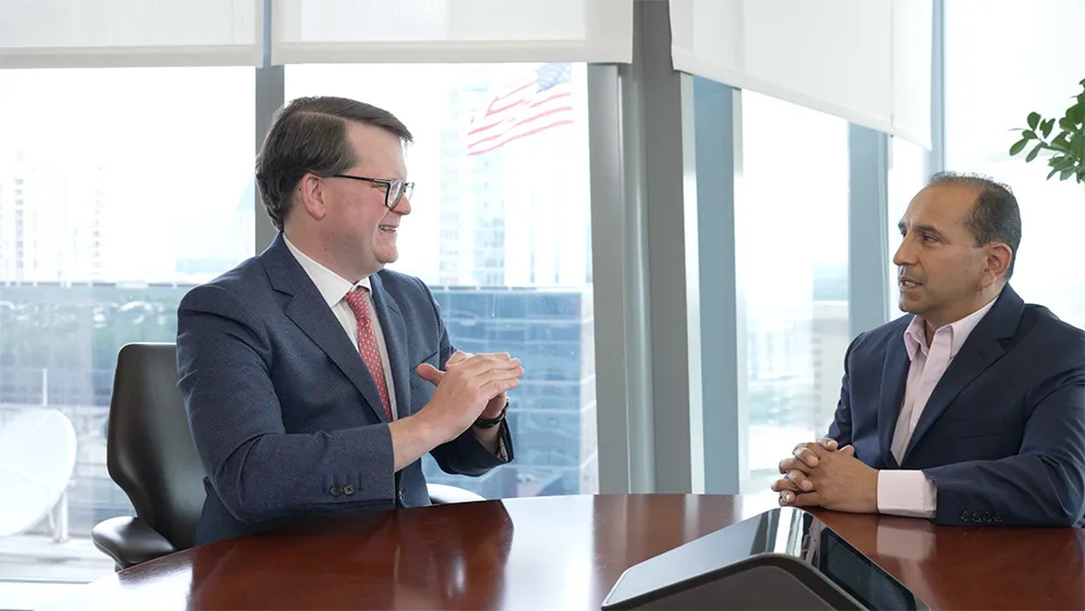 Happy relationship manager during client meeting explaining how well the client's portfolio did the year before