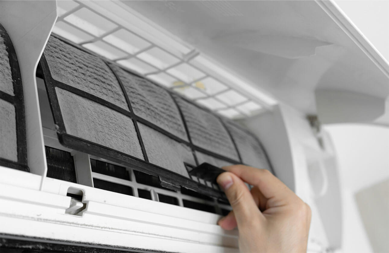 Local air conditioning expert cleaning indoor split system air conditioner filter in a Sydney home