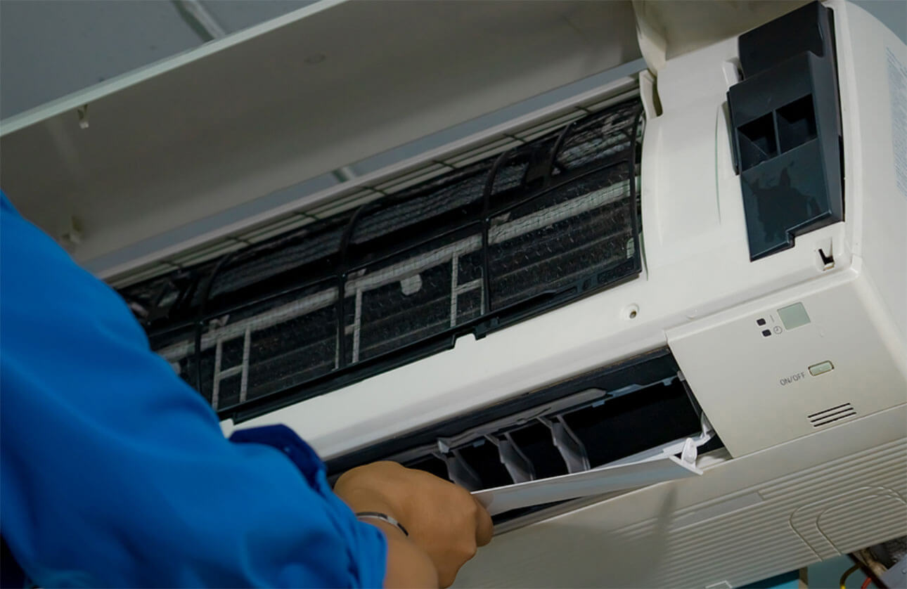 Aircon professional servicing a broken split system air conditioner