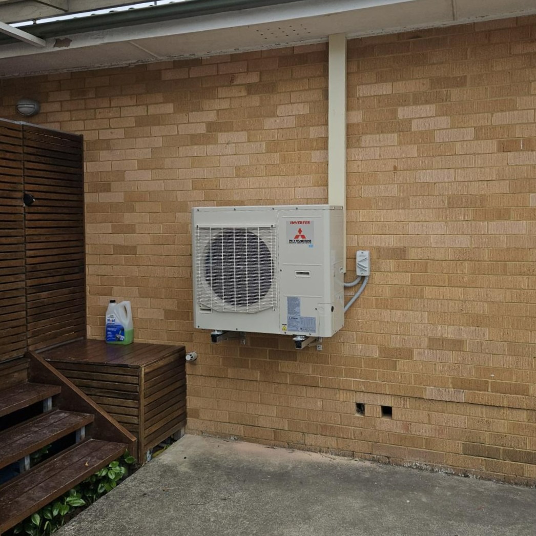 Mitsubishi air conditioning unit professionally installed on the exterior wall of a Northern Beaches home