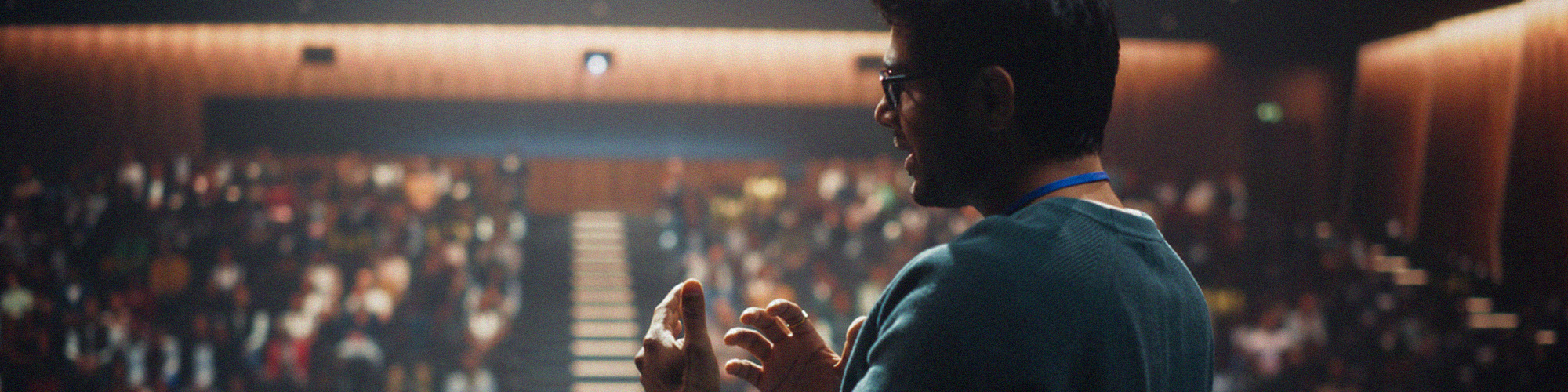 A person speaking in front of an audience.