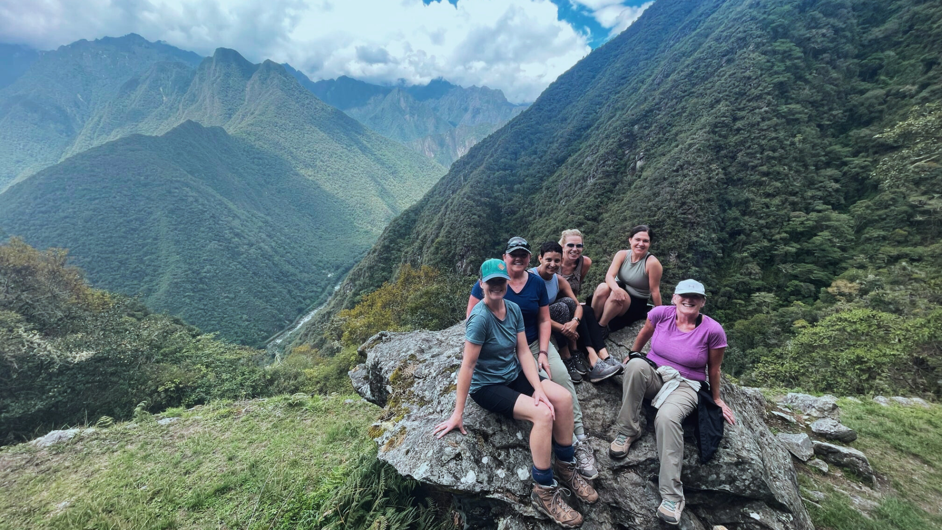 Woman presenting at conference. Audience is facing speaker with screen behind her