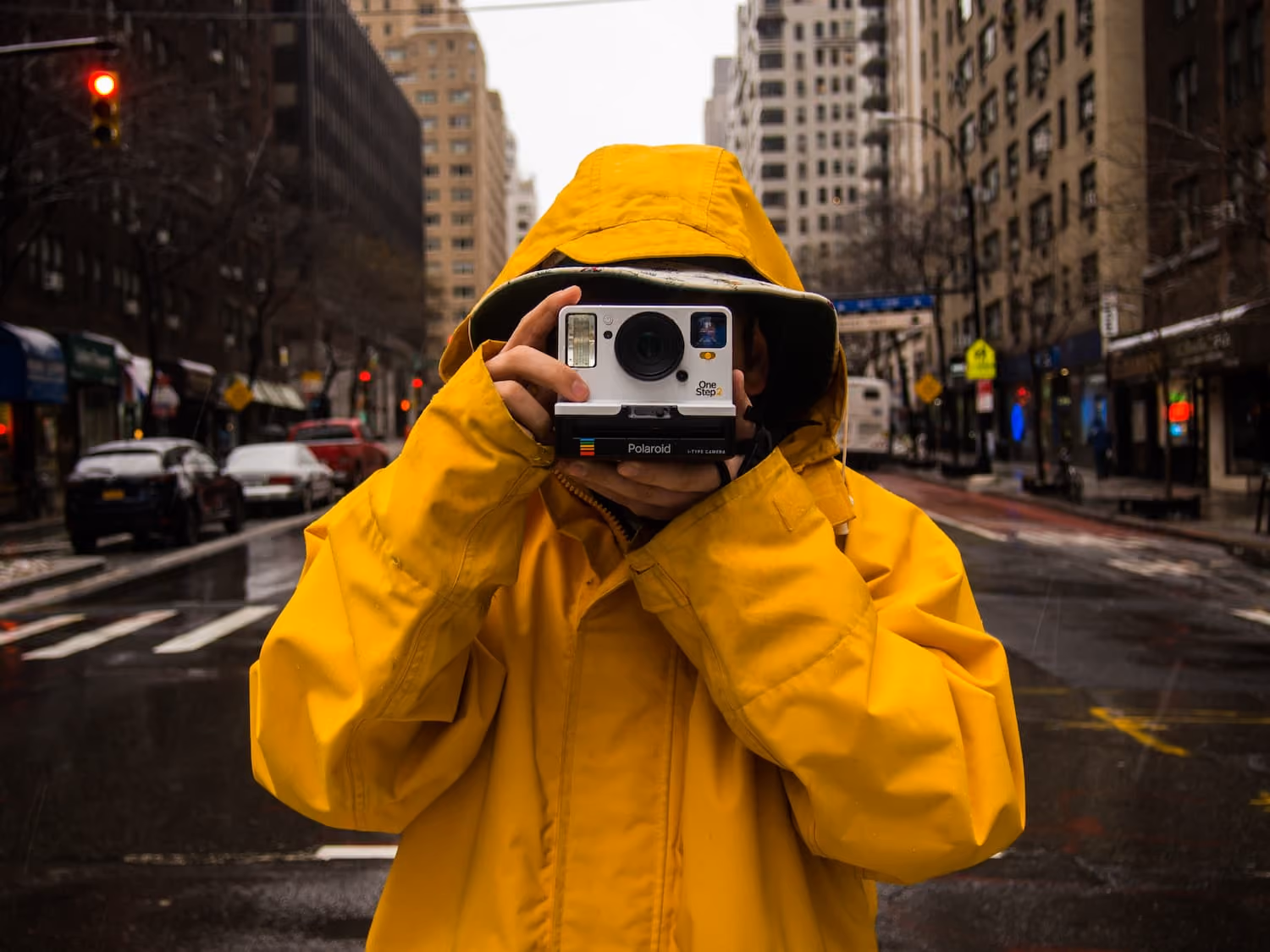 person holding instant camera photo