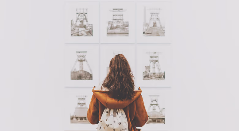 Woman pondering a painting in an art exhibition
