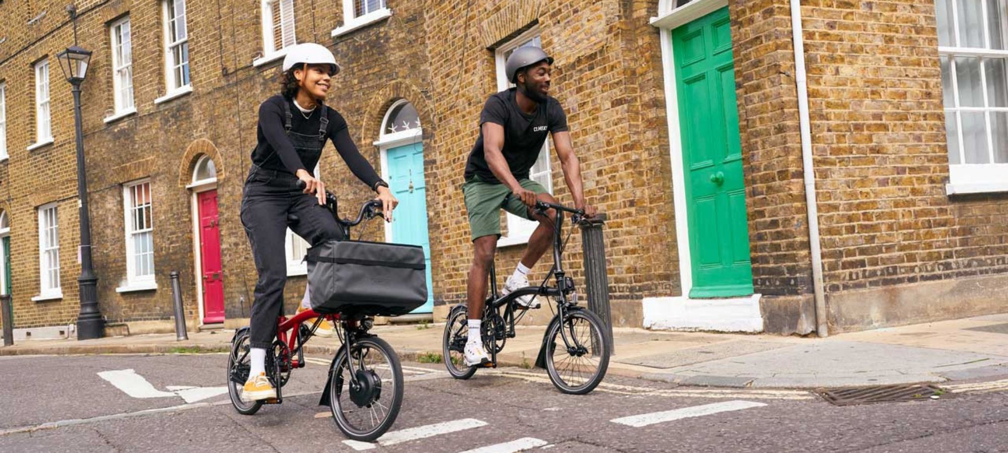 A man and woman cycling on Brompton folding bikes