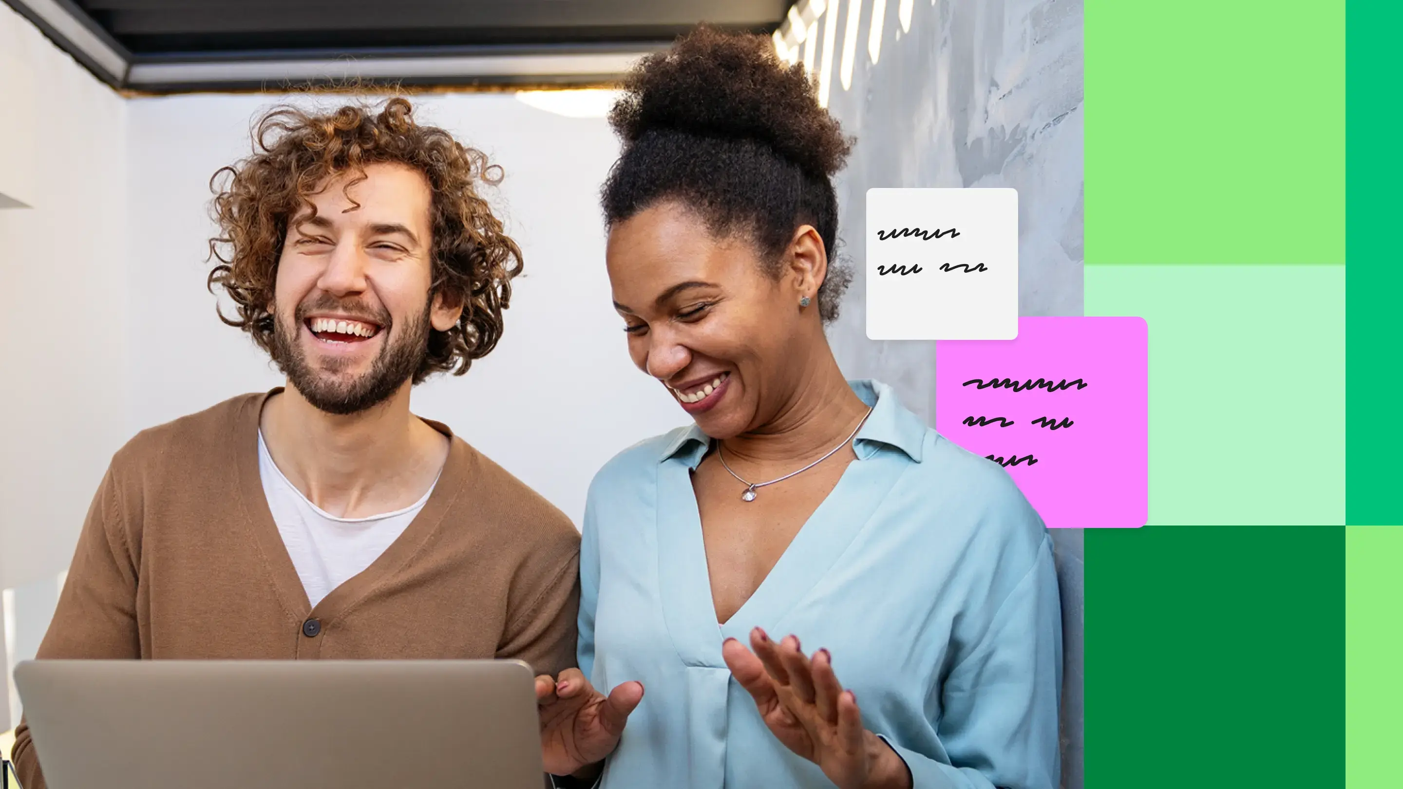 Two colleagues smiling and discussing AI readiness while using a laptop