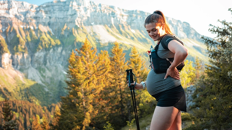 pregnant woman hiking in the mountains