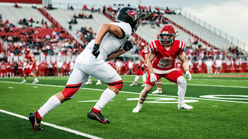 high school football players on the field during a game