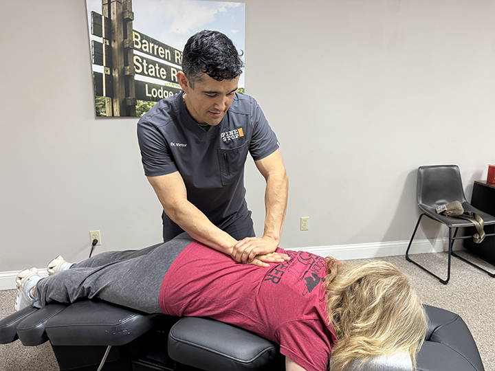 chiropractor dr. victor performs flexion distraction a patient's back
