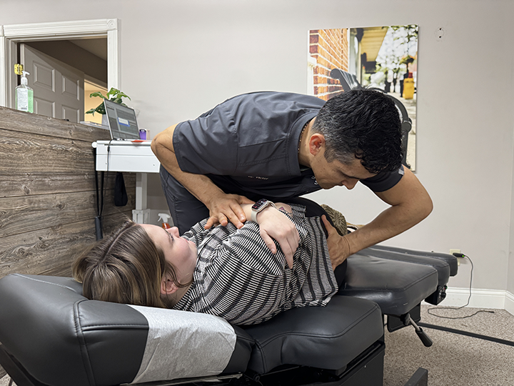 chiropractor dr. victor adjusts a patient's back