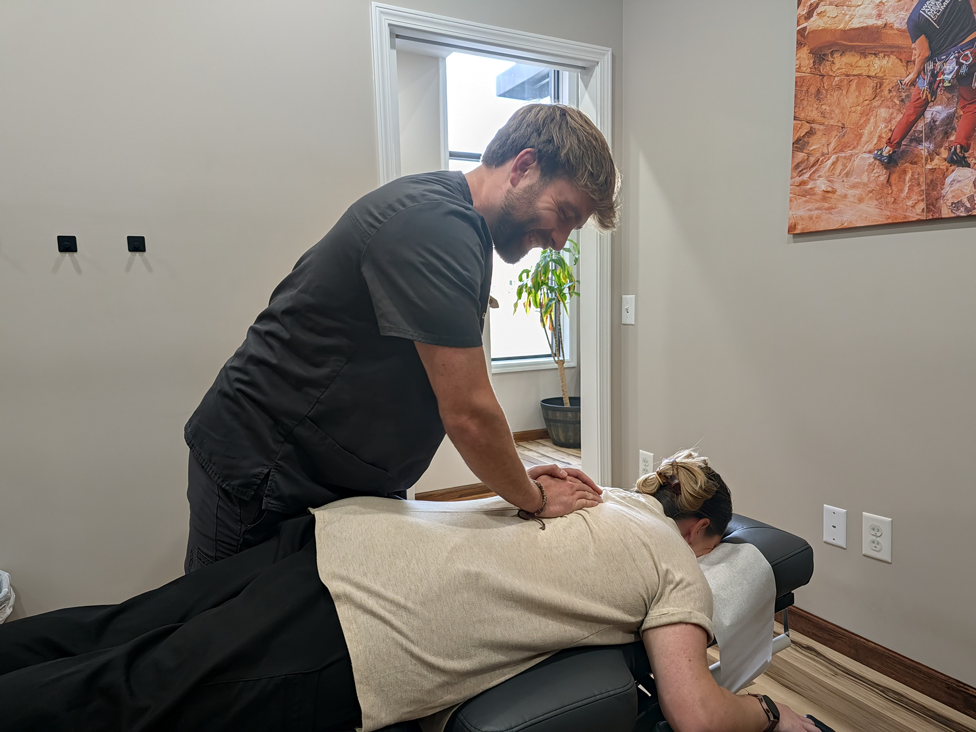 doctor witmer adjusts a patient's back.