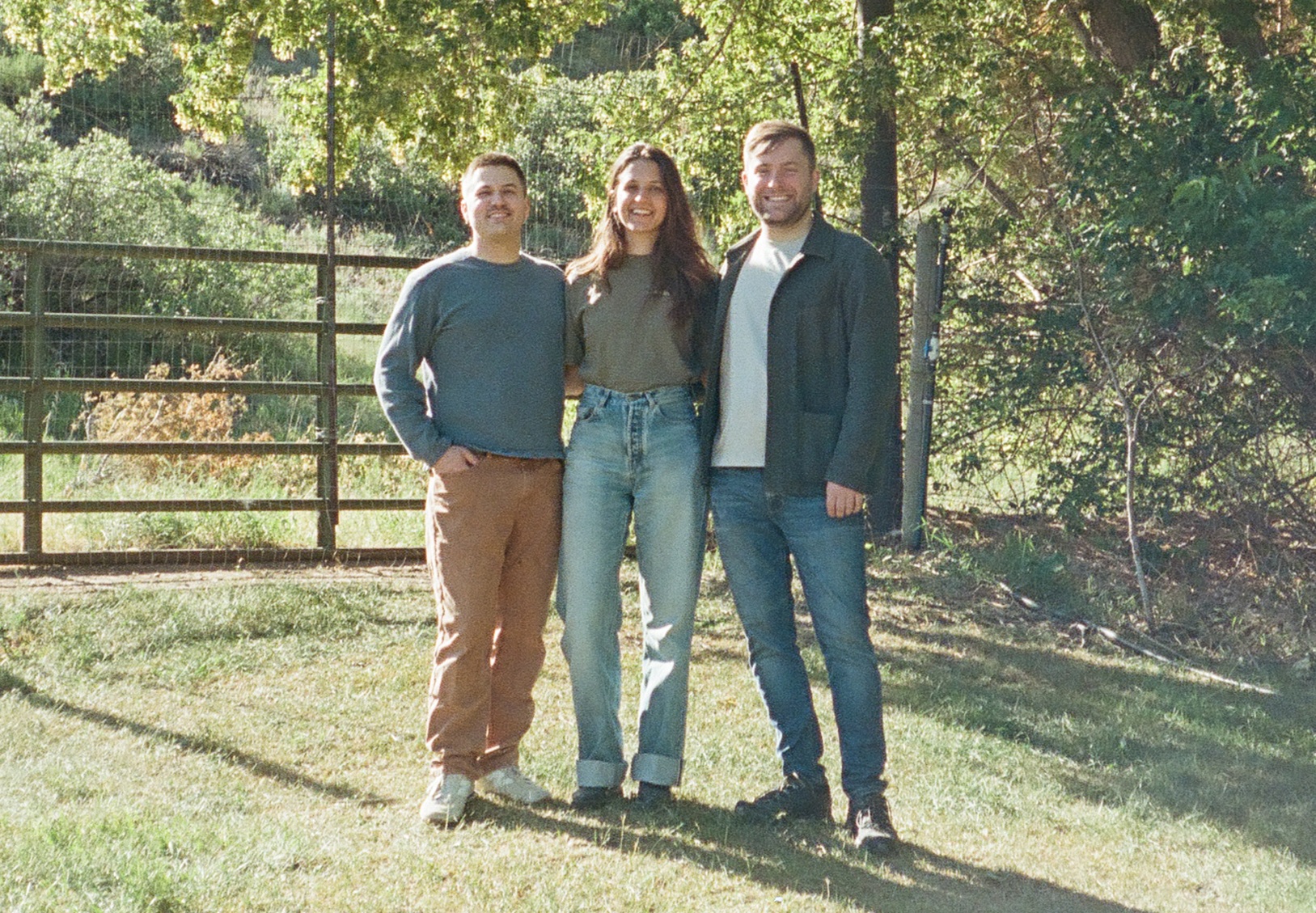 Photo of Mackenzie Burnett, Dan Schlosser & Jeff Anders standing in a field.