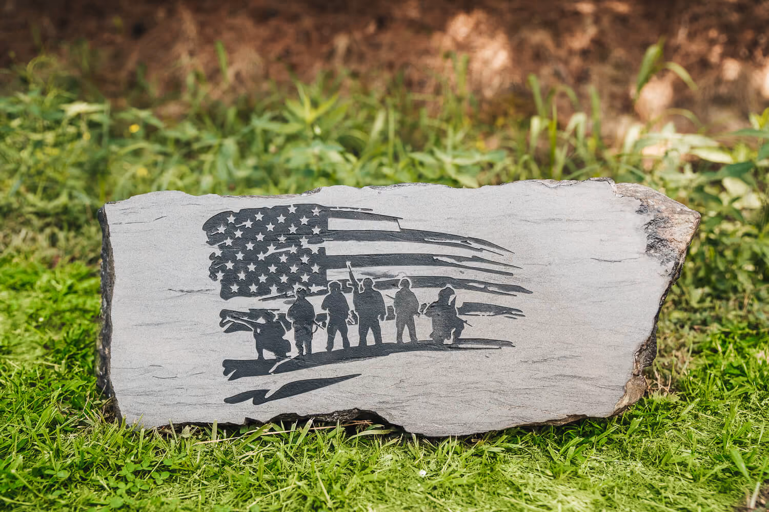Engraved stone with US flag and armies design