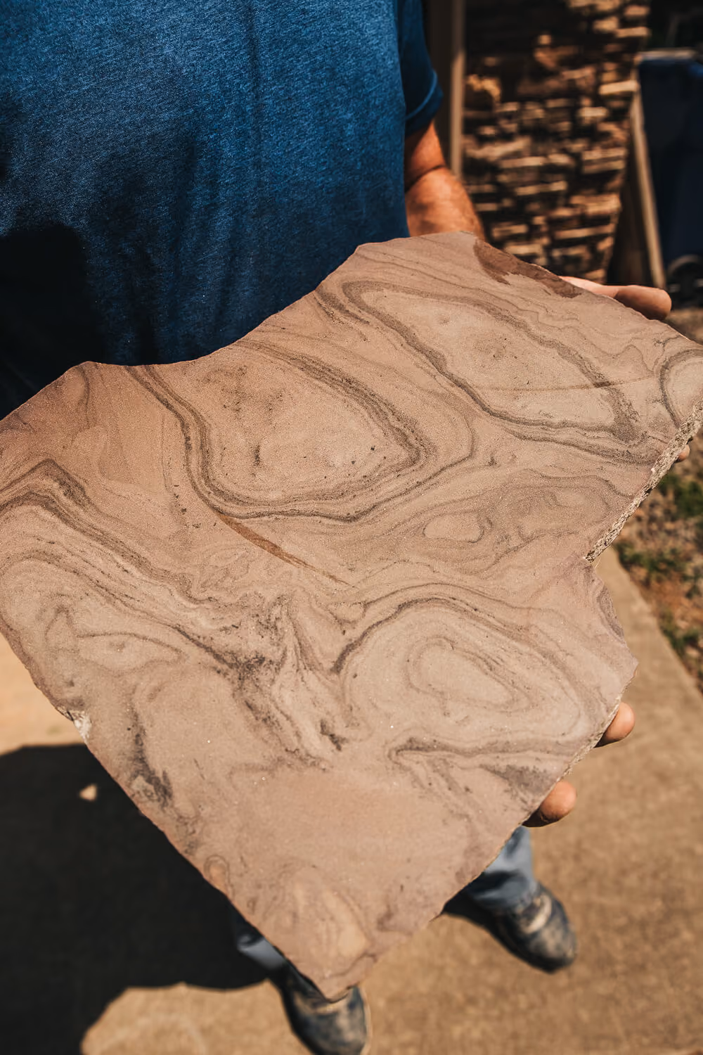 Owner of Griffin Stoneworks holding a clean stone for engraving