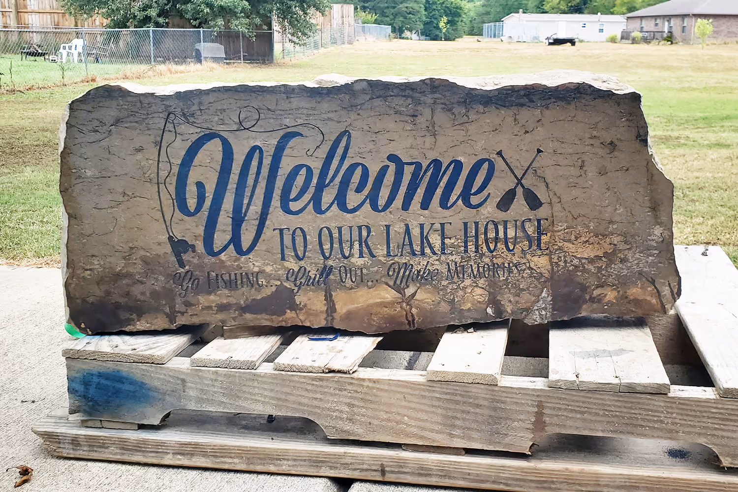Engraved Stone with welcome to our lake house sign